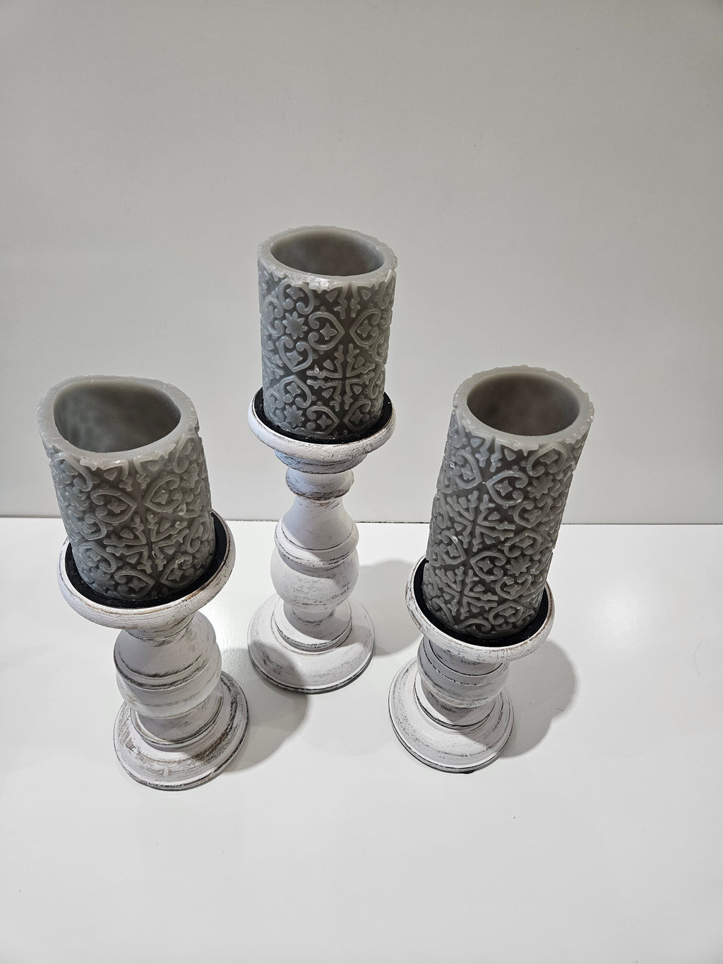 Set Of 3 Distressed White Wooden Pillar Candle Holders With Gray Embossed Candles