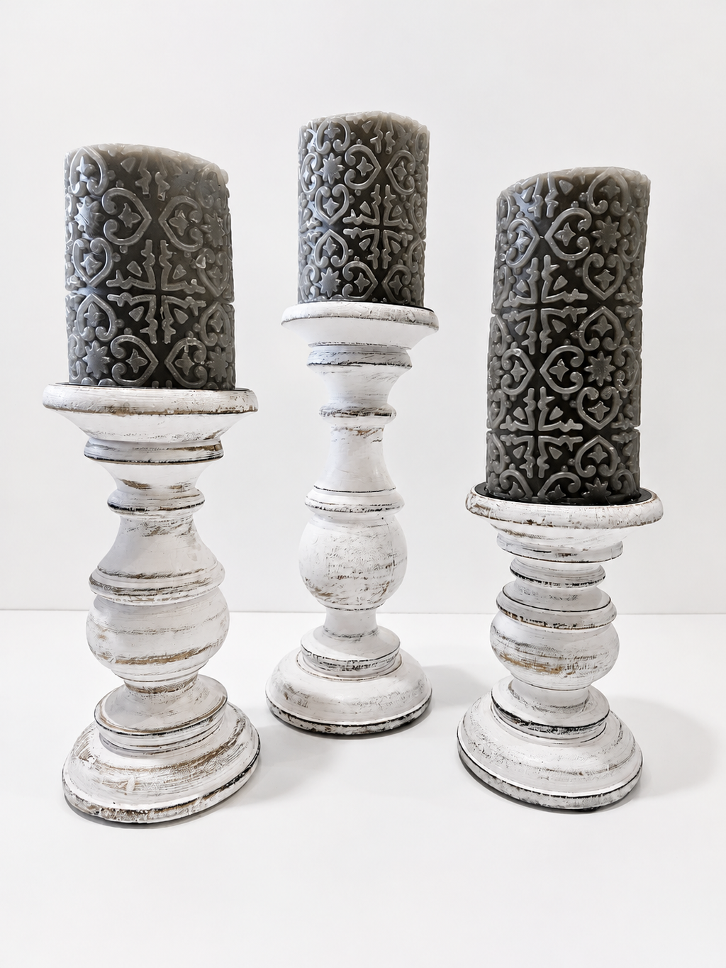 Set Of 3 Distressed White Wooden Pillar Candle Holders With Gray Embossed Candles