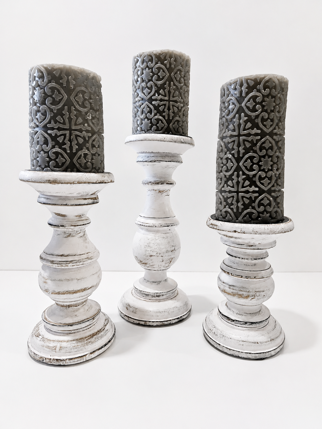 Set Of 3 Distressed White Wooden Pillar Candle Holders With Gray Embossed Candles