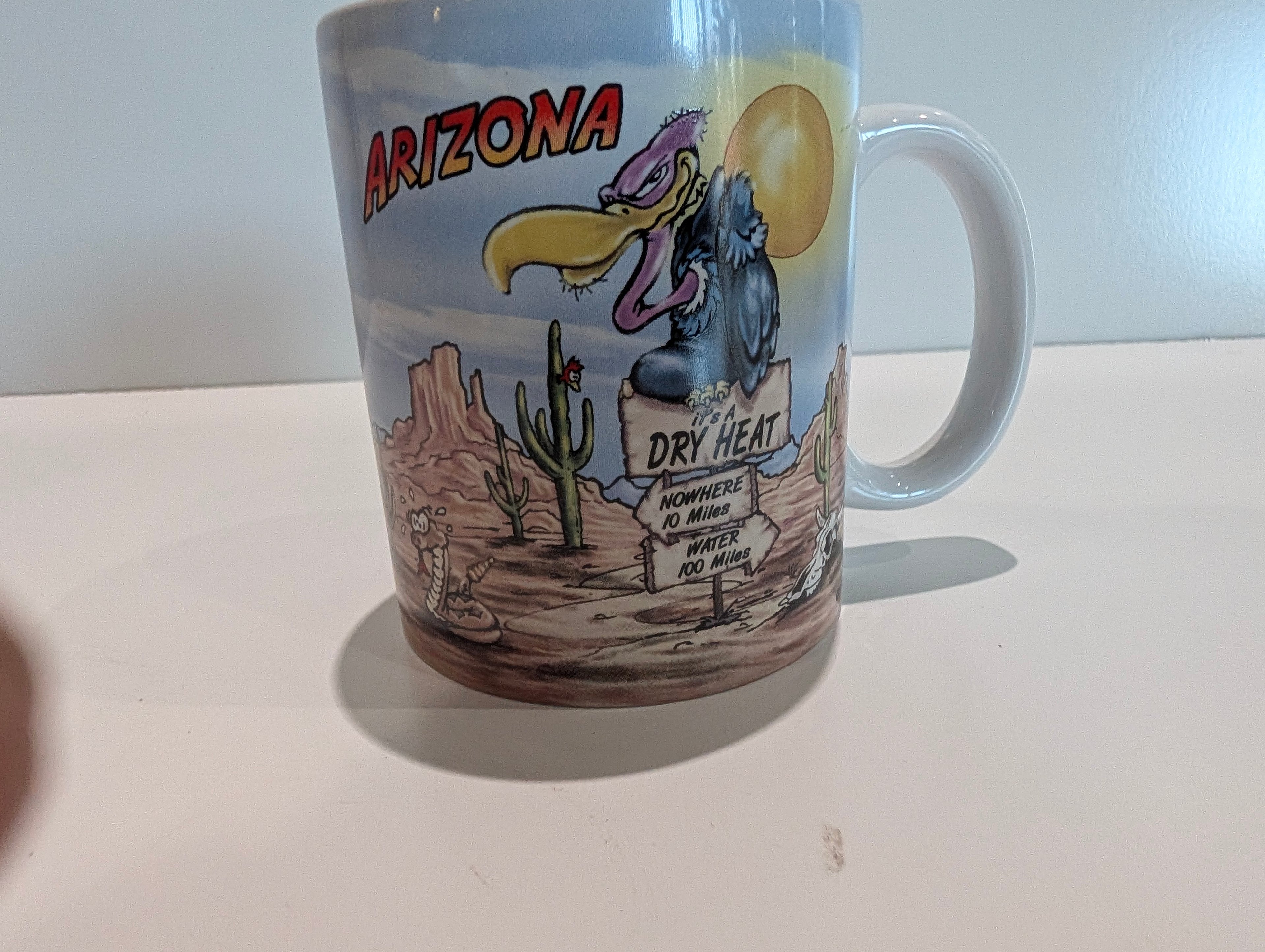 Arizona Desert Buzzard Cartoon Souvenir Coffee Mug Cup Dry Heat Cactus Scene